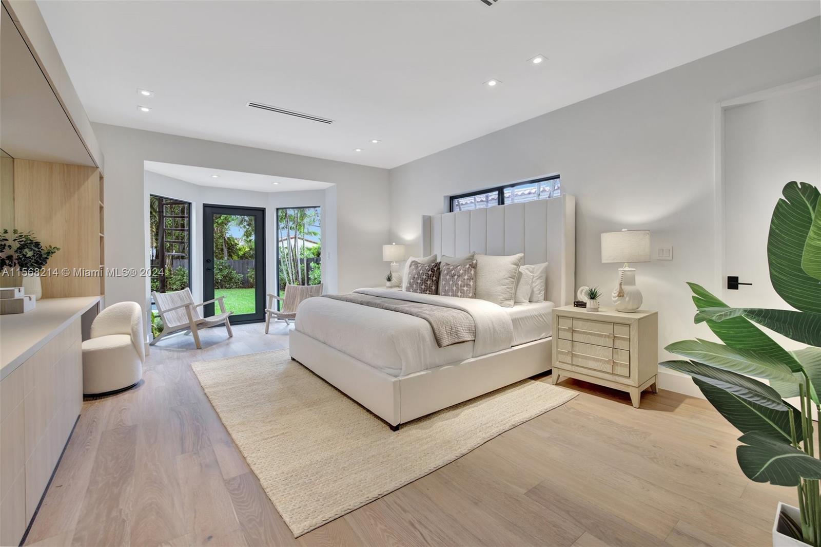 4321 Alton Road Miami Beach, FL 33140 - Photo 26 of 56 a bedroom with a large bed and a flat screen television