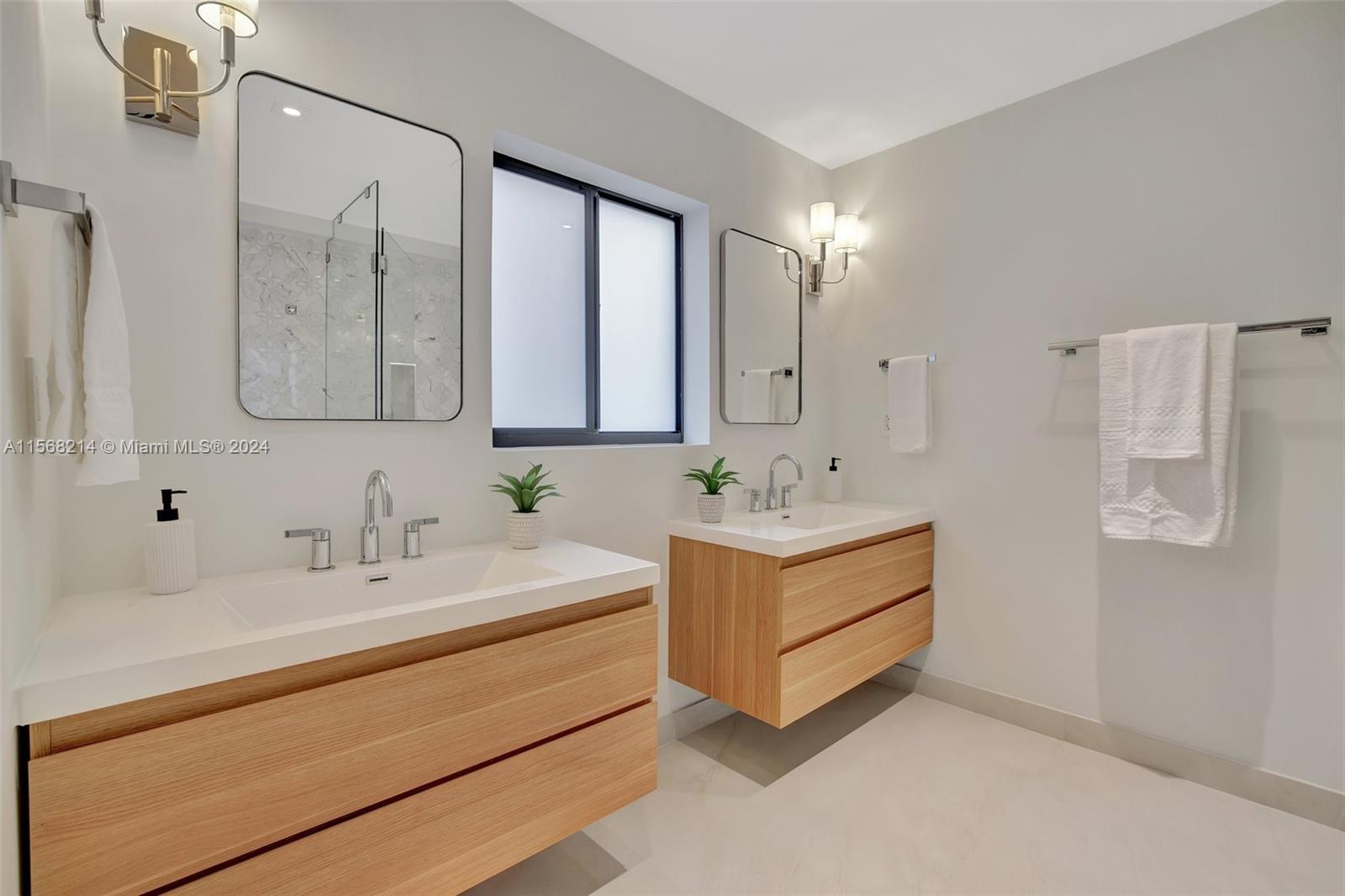 4321 Alton Road Miami Beach, FL 33140 - Photo 30 of 56 a bathroom with a double vanity sink mirror and double