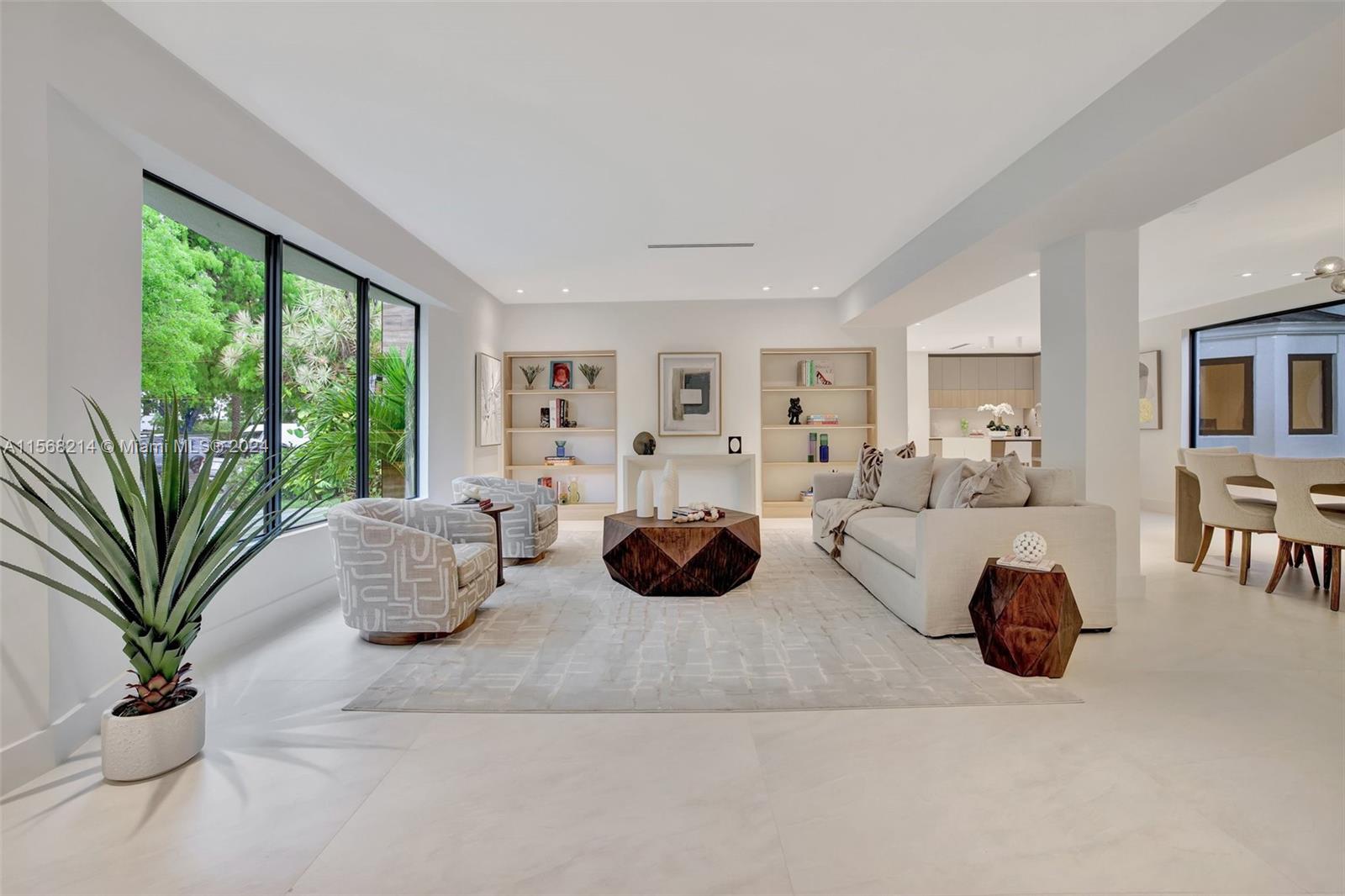4321 Alton Road Miami Beach, FL 33140 - Photo 3 of 56 a living room with furniture potted plant and a large window