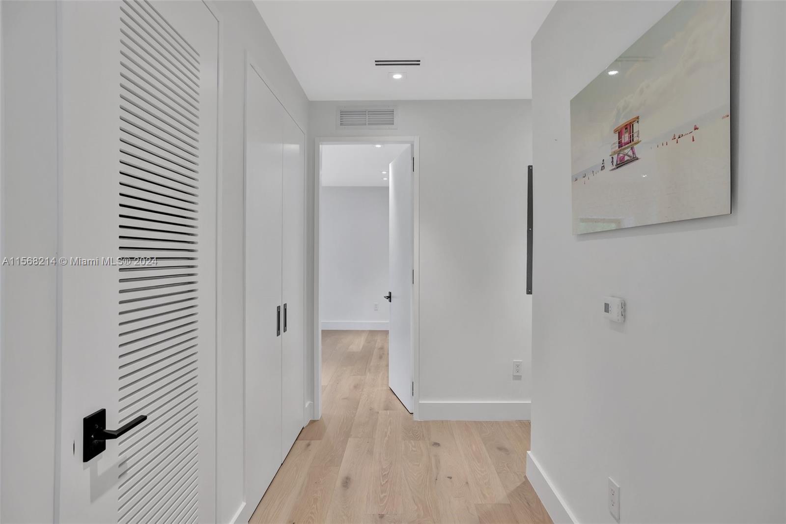 4321 Alton Road Miami Beach, FL 33140 - Photo 38 of 56 a view of a hallway with paintings on the wall