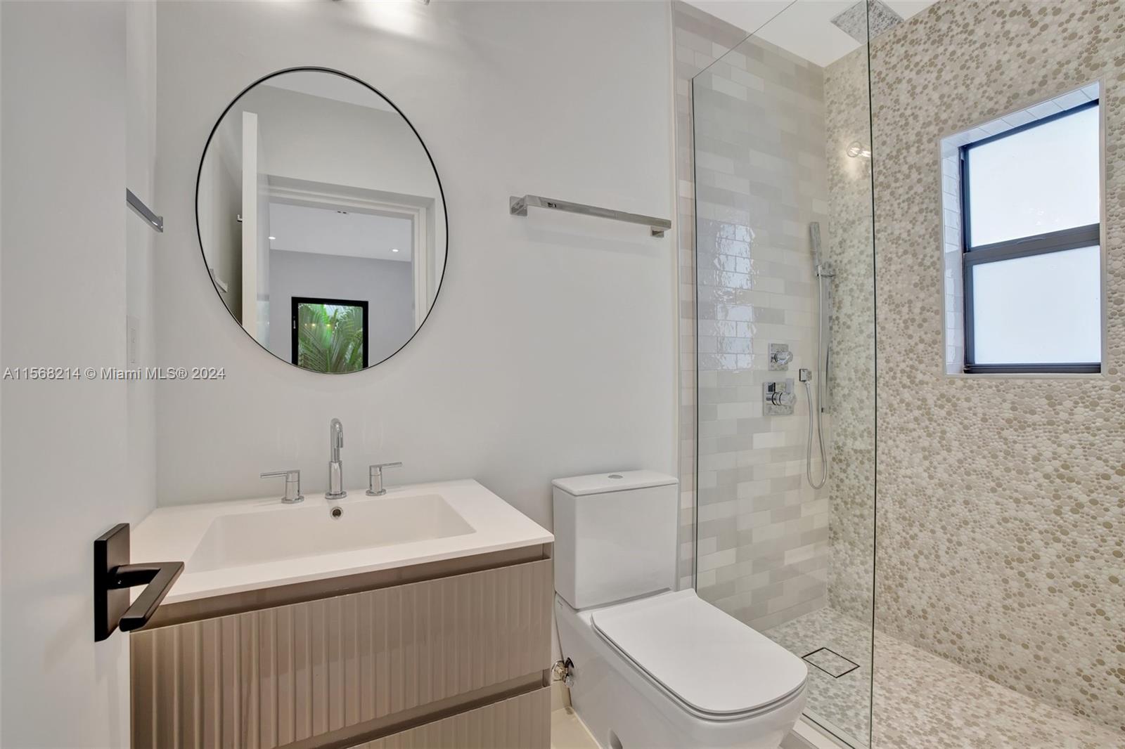 4321 Alton Road Miami Beach, FL 33140 - Photo 43 of 56 a bathroom with a sink toilet and shower