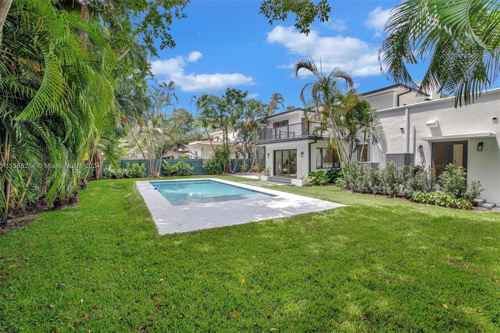 4321 Alton Road Miami Beach, FL 33140 - Photo 46 of 56 a front view of a house with a yard and palm trees