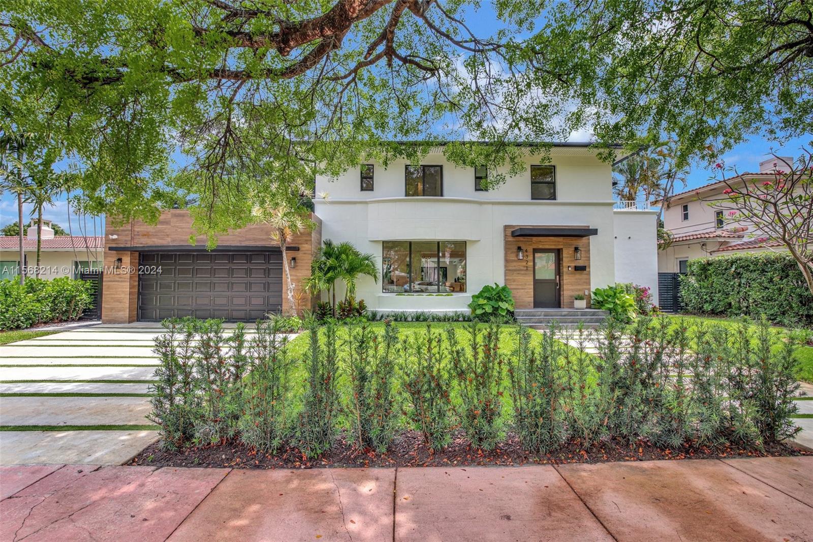4321 Alton Road Miami Beach, FL 33140 - Photo 49 of 56 front view of a house with a garden