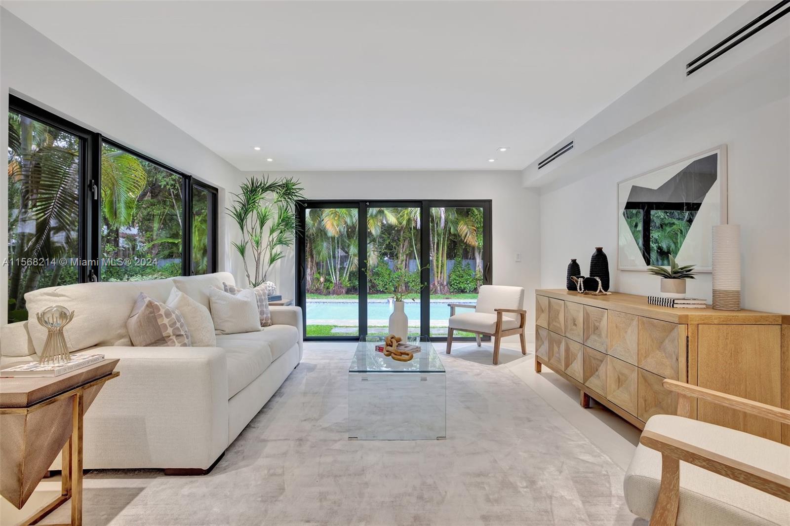 4321 Alton Road Miami Beach, FL 33140 - Photo 7 of 56 a living room with furniture and a large window