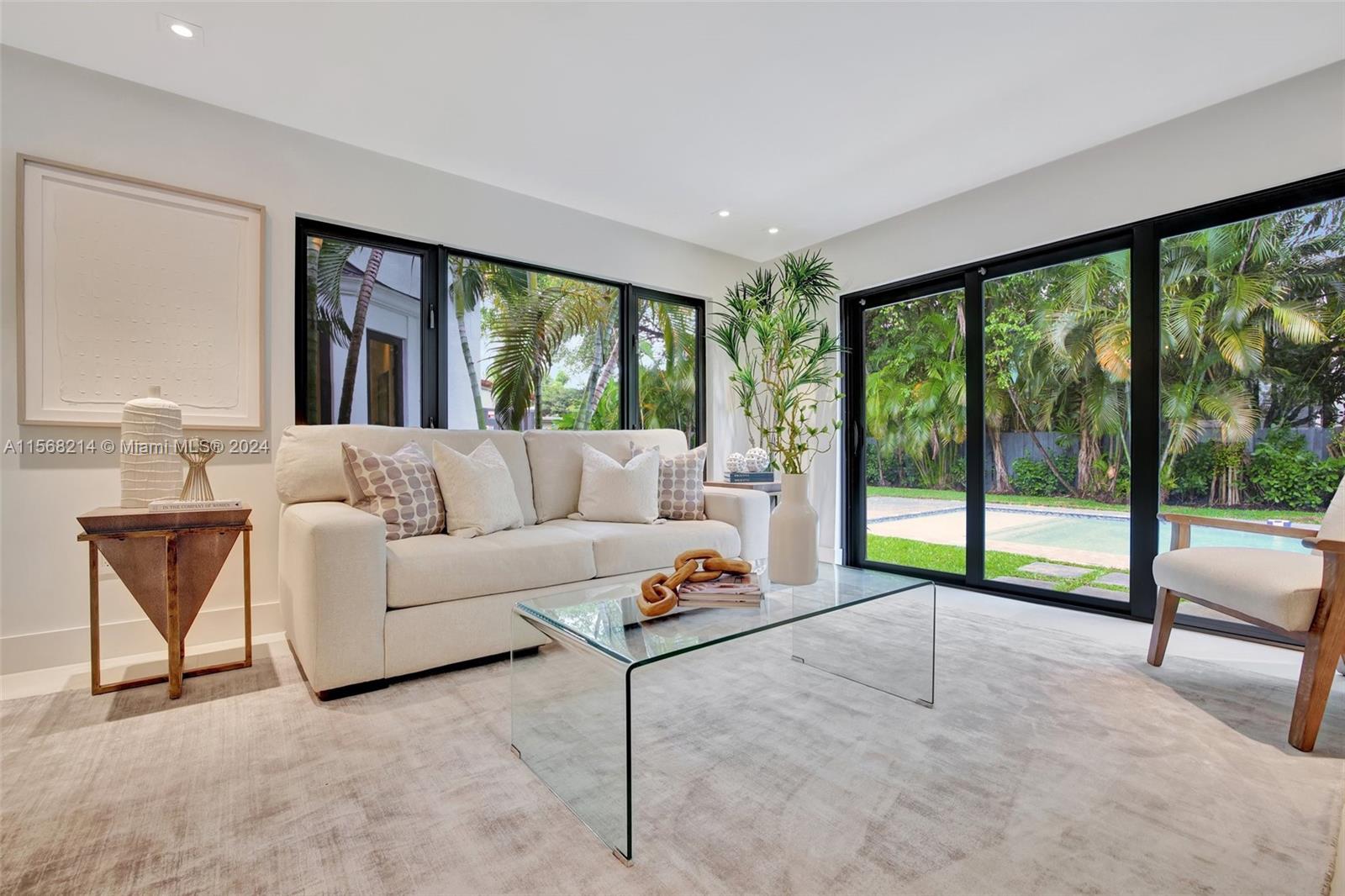 4321 Alton Road Miami Beach, FL 33140 - Photo 9 of 56 a living room with furniture and a large window