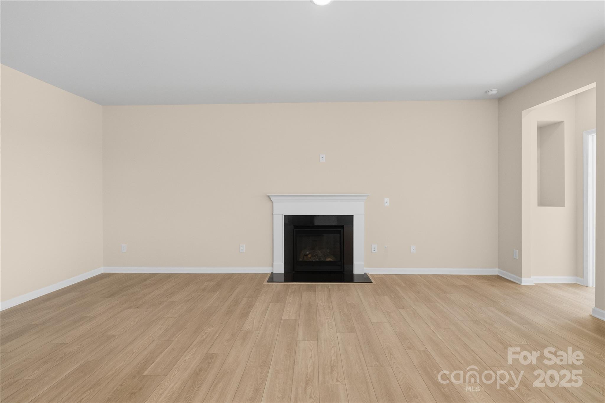 5404 Redbud Road Lancaster, SC 29720 - Photo 7 of 27 a view of an empty room with wooden floor and a fireplace