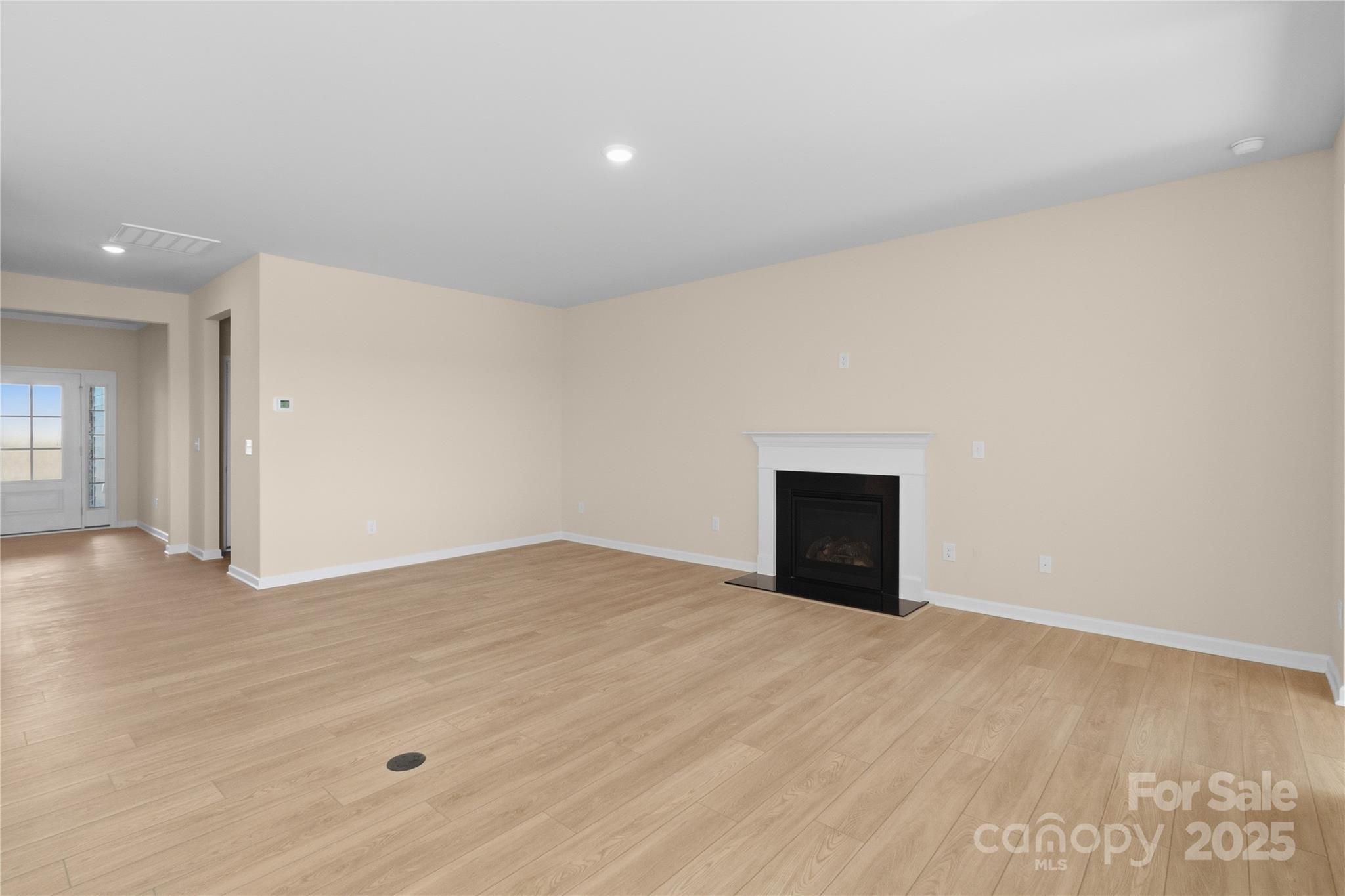 5404 Redbud Road Lancaster, SC 29720 - Photo 8 of 27 a view of an empty room with wooden floor and a window