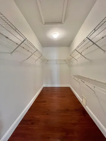 a bathroom with a granite countertop sink mirror and a toilet
