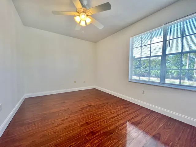 wooden floor in an empty room with a window