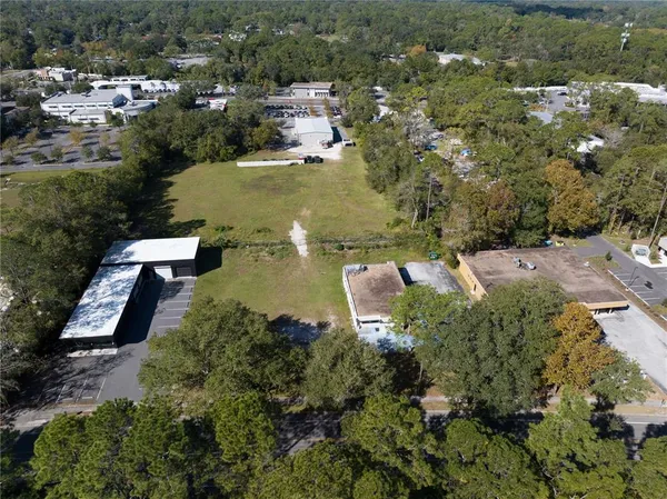 an aerial view of residential houses with outdoor space and river