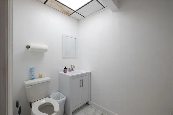 a room with gym equipment and a refrigerator