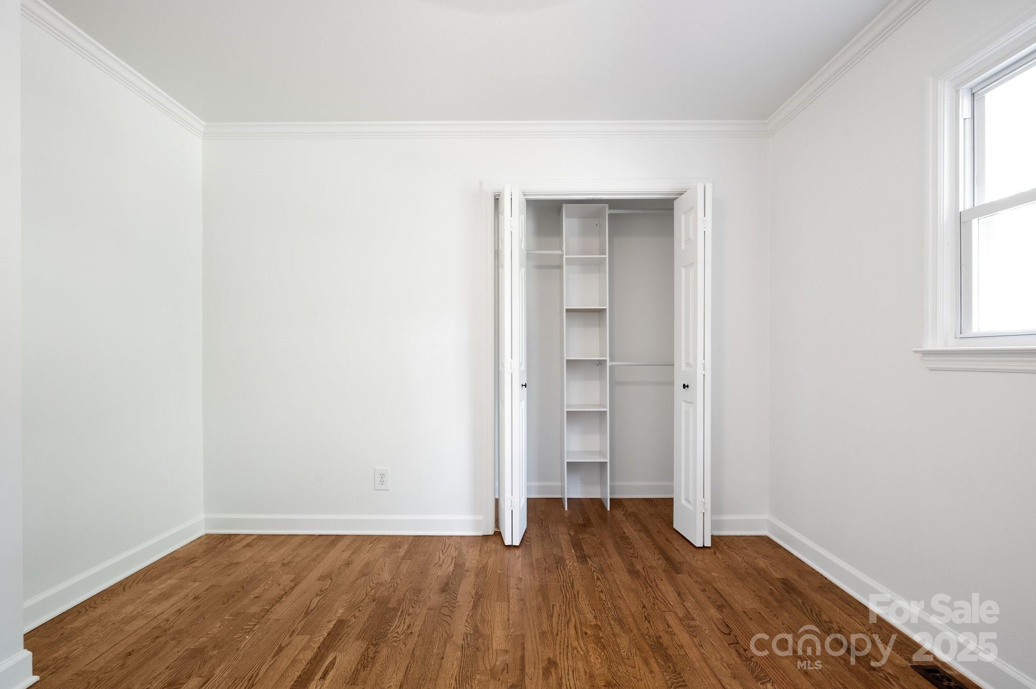 28 Spaulding Road Candler, NC 28715 - Photo 11 of 31 an empty room with wooden floor and windows