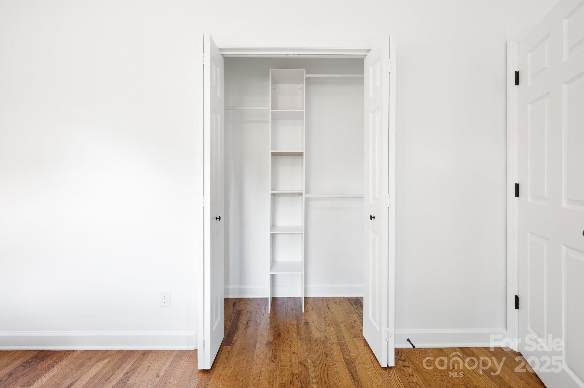 28 Spaulding Road Candler, NC 28715 - Photo 18 of 31 a view of hallway with walk in closet and wooden floor