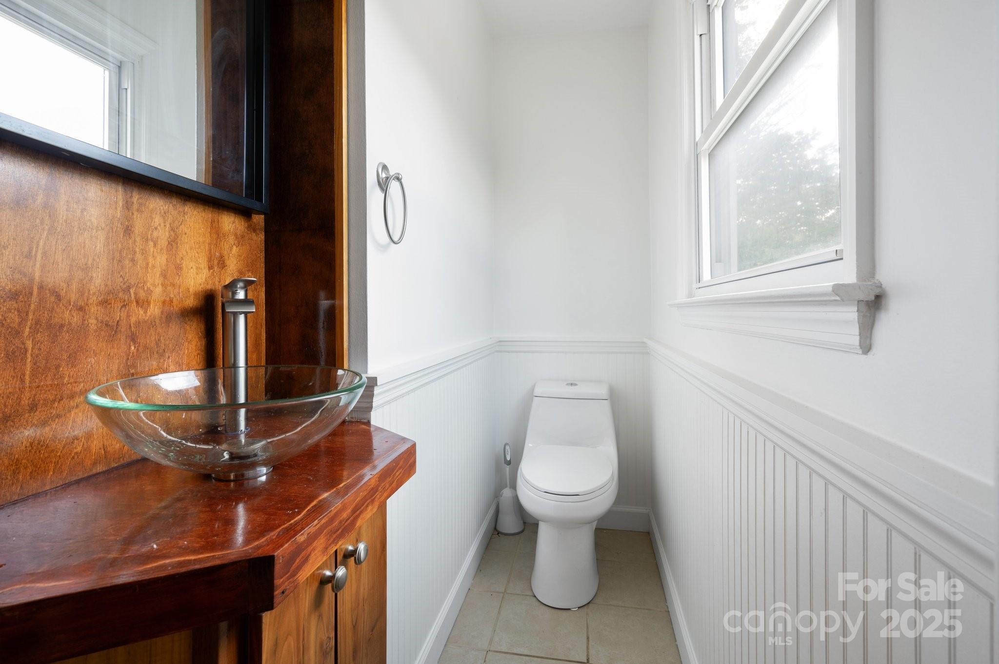 28 Spaulding Road Candler, NC 28715 - Photo 19 of 31 a bathroom with a toilet and a sink