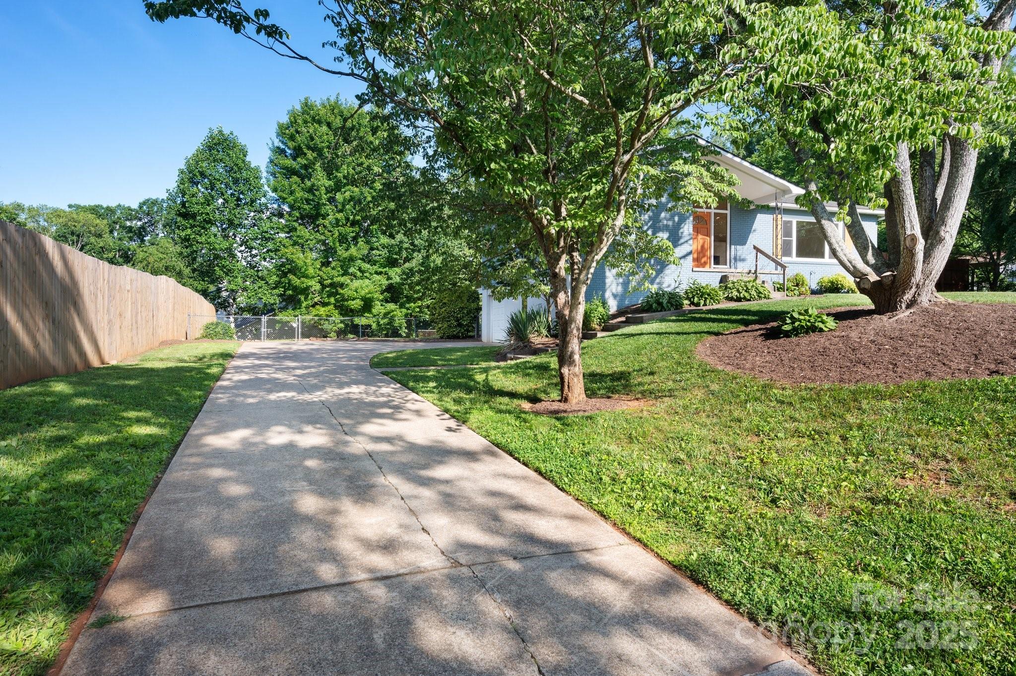 28 Spaulding Road Candler, NC 28715 - Photo 2 of 31 a view of yard in front of house with trees all around