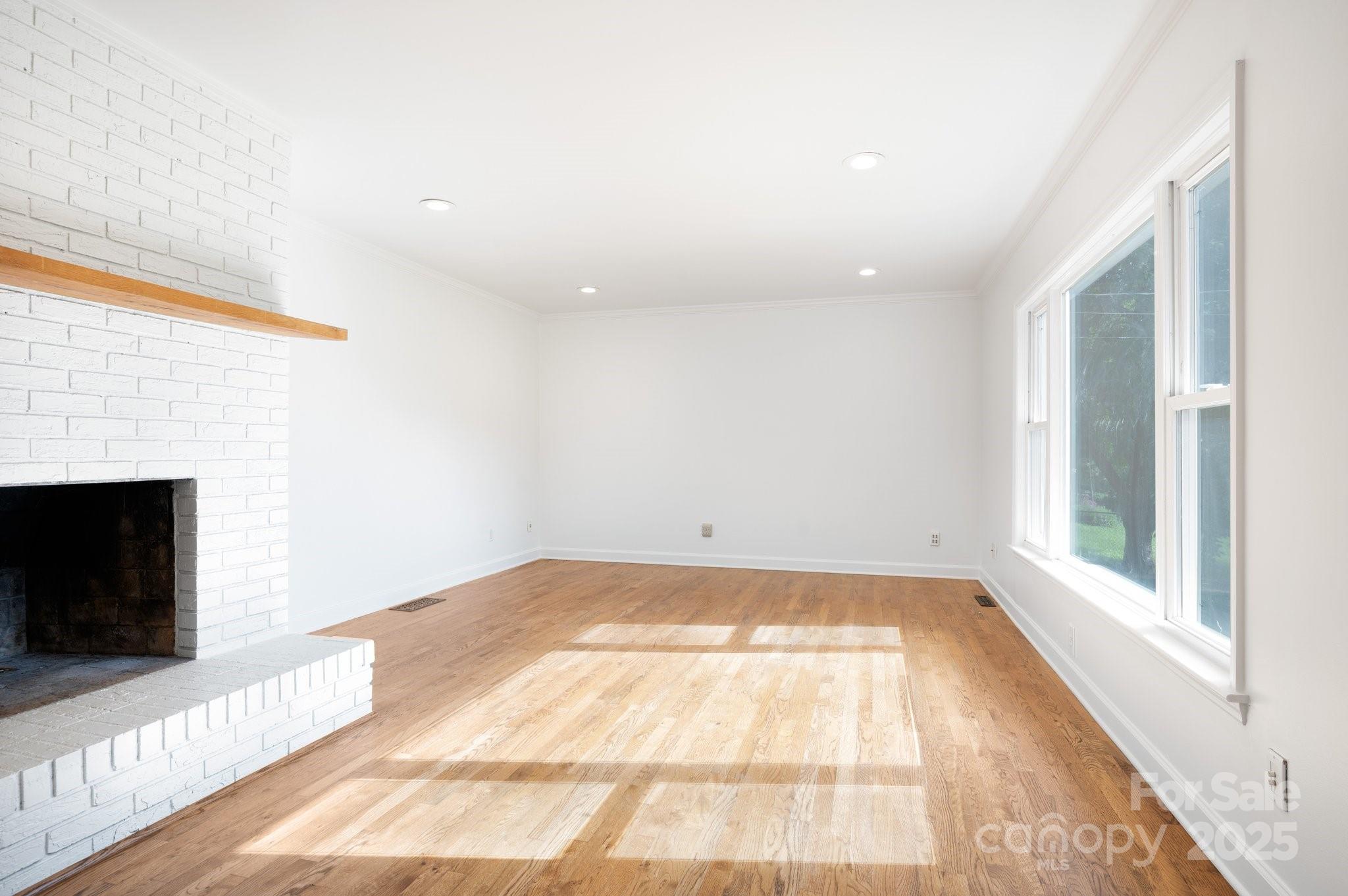 28 Spaulding Road Candler, NC 28715 - Photo 6 of 31 a view of an empty room with a fireplace and a window