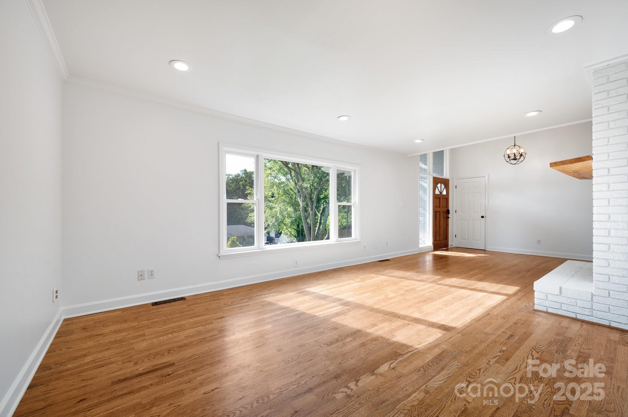 28 Spaulding Road Candler, NC 28715 - Photo 9 of 31 a view of empty room with wooden floor and fan
