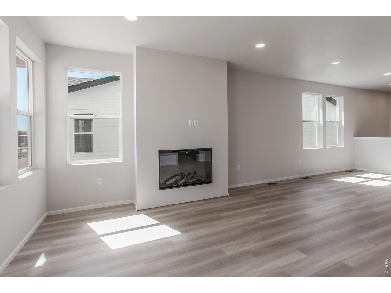 792 Chatter Road Windsor, CO 80550 - Photo 24 of 49 a view of an empty room with wooden floor and a window
