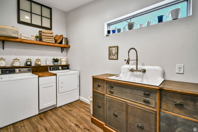 544 East 600 North, Unit 1 Joseph, UT 84739 - Photo 34 of 65 Utility room featuring wood-finish flooring, a white porcelain utility sink with a wall-mounted faucet, and a countertop with integrated cabinetry