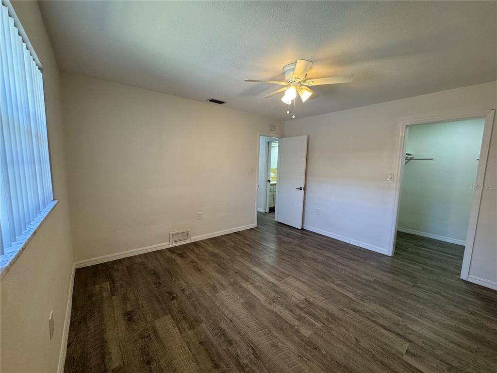 629 Rugby Street Orlando, FL 32804 - Photo 13 of 19 an empty room with wooden floor and windows