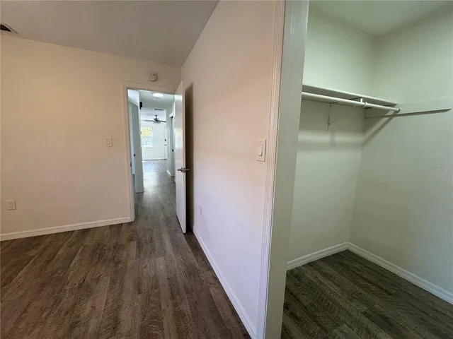 a view of hallway with wooden floor