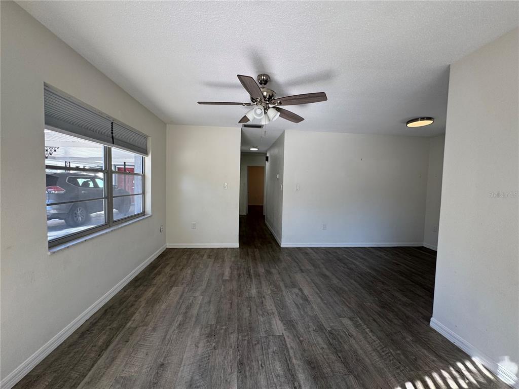 629 Rugby Street Orlando, FL 32804 - Photo 3 of 19 a view of empty room with wooden floor and fan