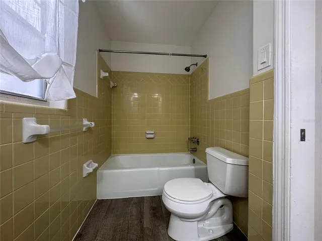 a bathroom with a toilet and a bath tub