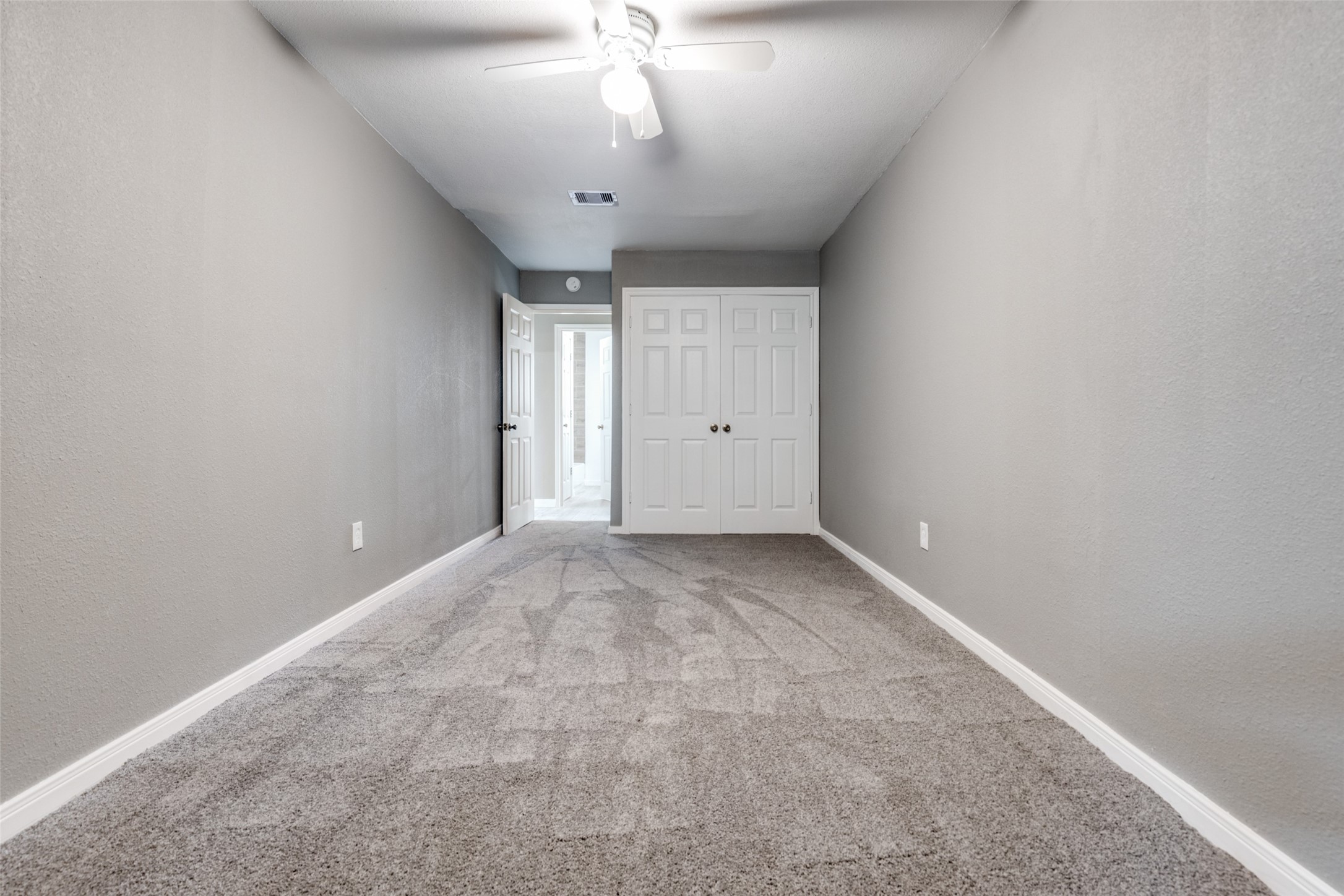 200 Pine Street Prairie View, TX 77446 - Photo 16 of 25 an empty room with a chandelier fan and windows