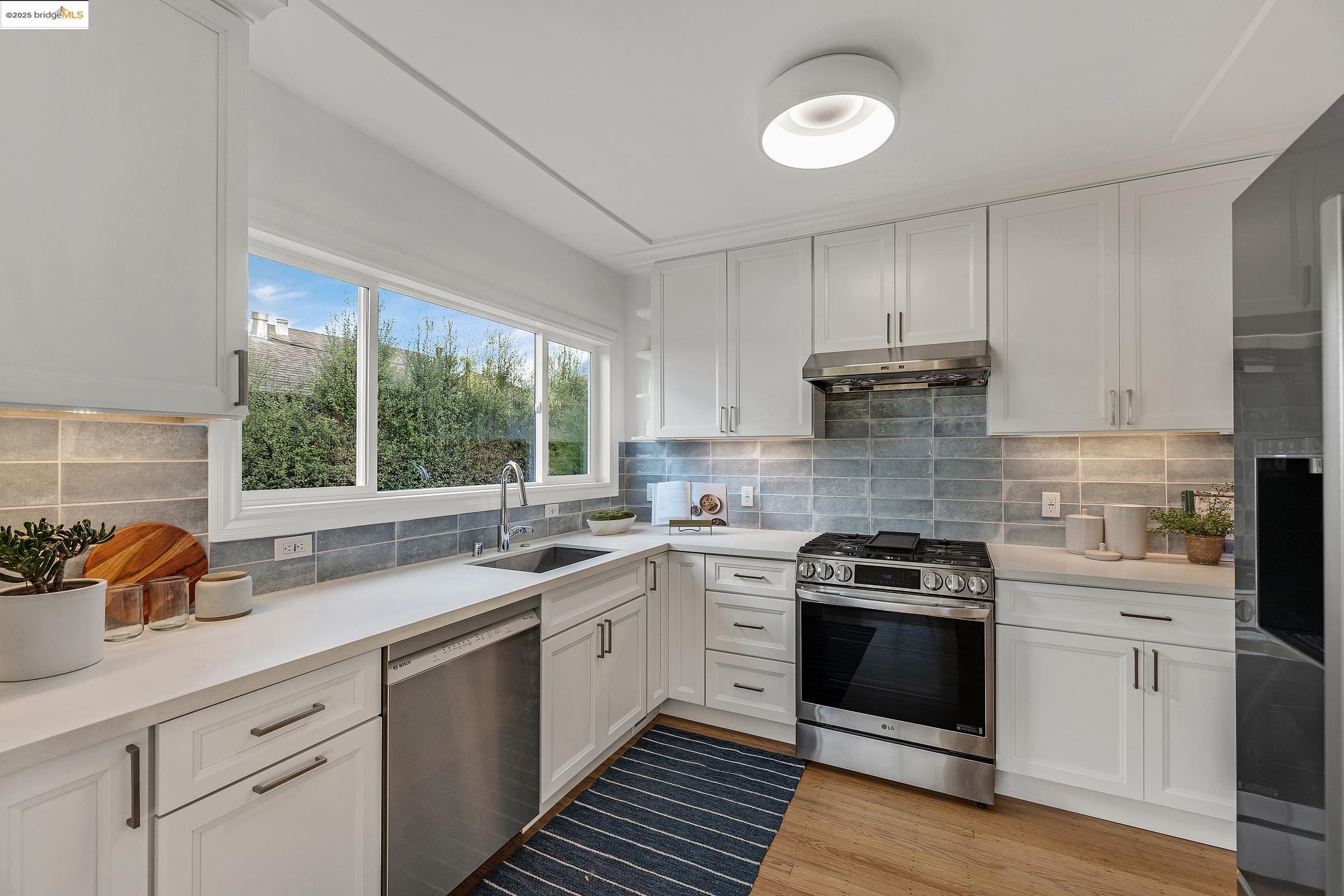 1515 Derby Street Berkeley, CA 94703 - Photo 13 of 60 a kitchen with a stove a sink and a window
