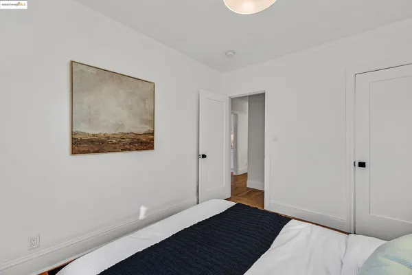 a bedroom with a bed and a mirror