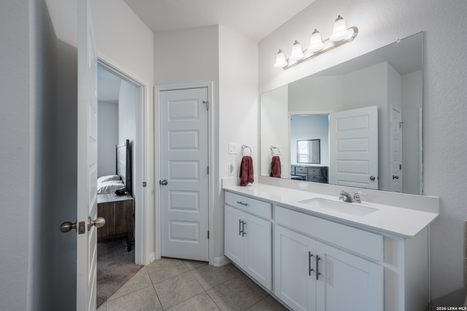4947 Ranahan Pass St. Hedwig, TX 78152 - Photo 21 of 37 a spacious bathroom with a double vanity sink mirror and toilet