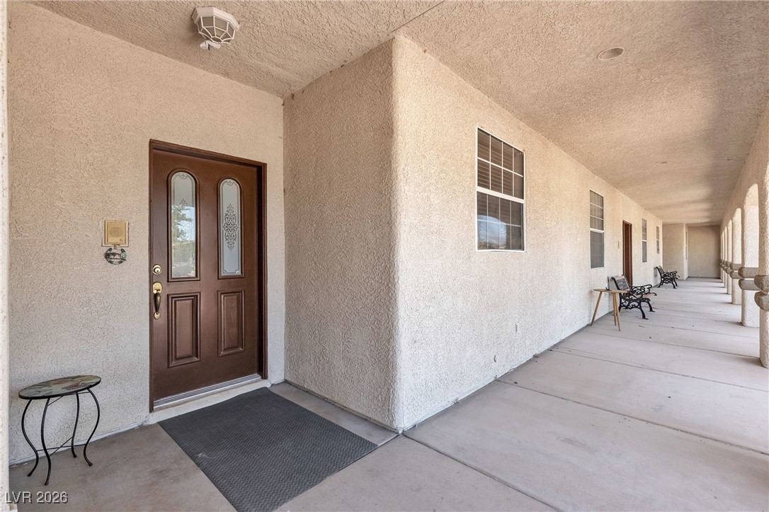 825 West Ryan Avenue Overton, NV 89040 - Photo 21 of 88 View of exterior entry with stucco siding and covered porch