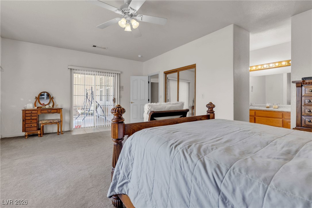 825 West Ryan Avenue Overton, NV 89040 - Photo 30 of 88 Carpeted bedroom with a ceiling fan and connected bathroom