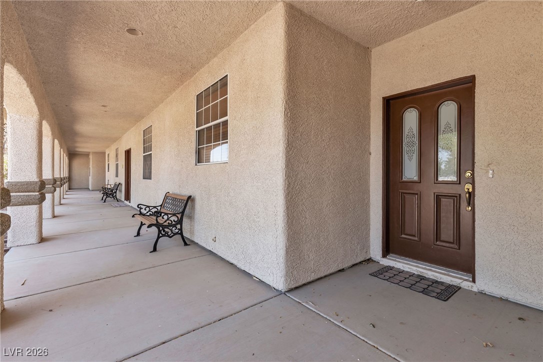 825 West Ryan Avenue Overton, NV 89040 - Photo 50 of 88 View of exterior entry featuring stucco siding and covered porch