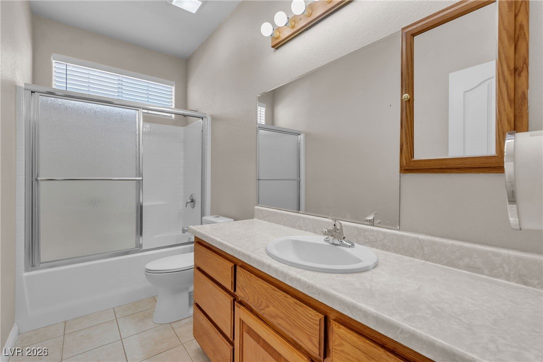 825 West Ryan Avenue Overton, NV 89040 - Photo 62 of 88 Full bathroom with vanity, tile patterned flooring, and combined bath / shower with glass door