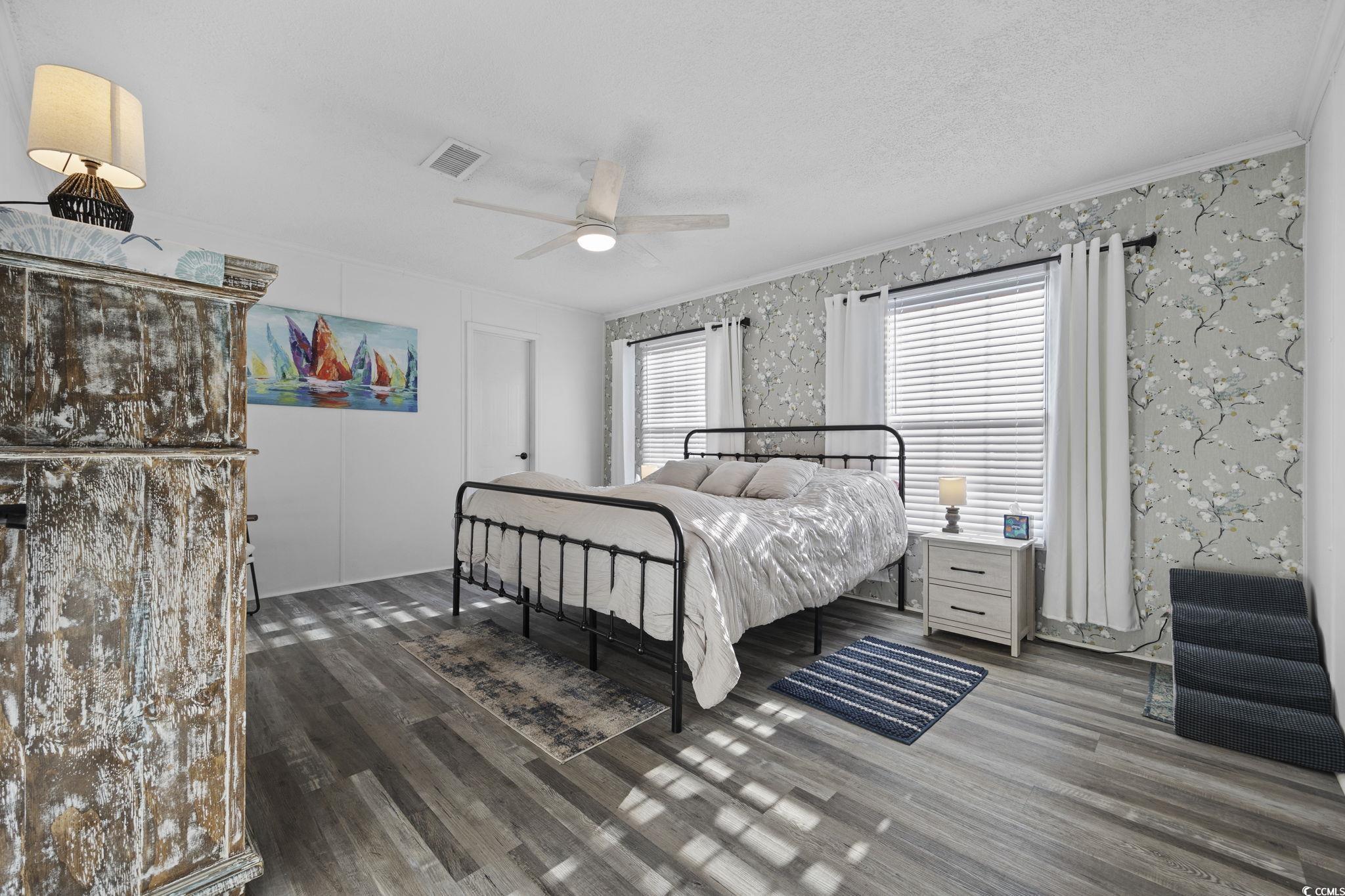 944 Pine Thicket Street Myrtle Beach, SC 29577 - Photo 12 of 27 Bedroom with dark wood finished floors, ceiling fan, ornamental molding, and a textured ceiling