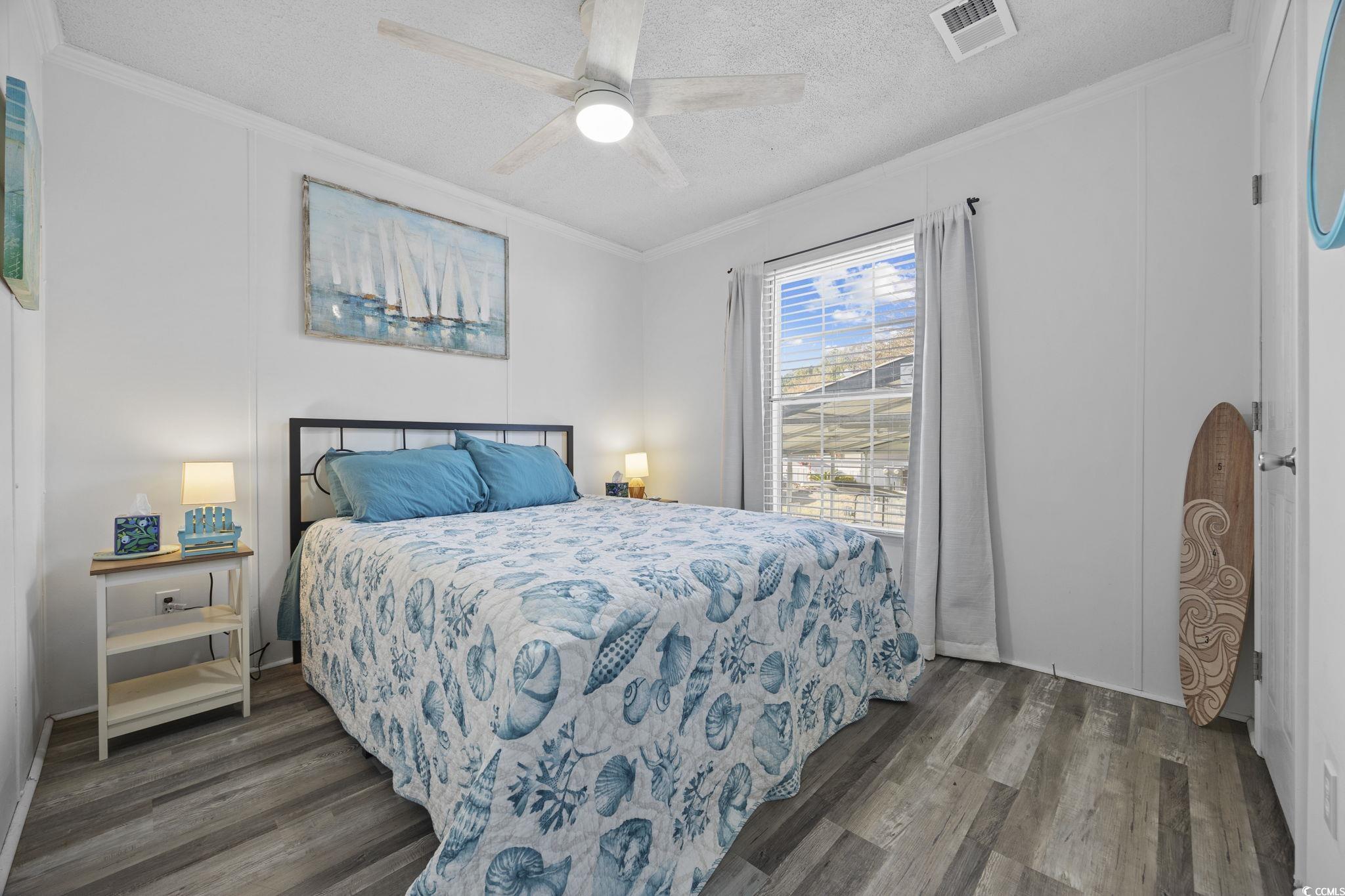 944 Pine Thicket Street Myrtle Beach, SC 29577 - Photo 17 of 27 Bedroom with ornamental molding, dark wood-style floors, ceiling fan, and a textured ceiling