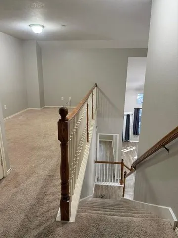 an empty room with closet and a chandelier fan