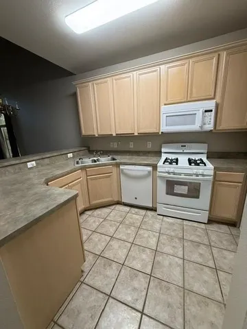 a kitchen with a stove sink and cabinets