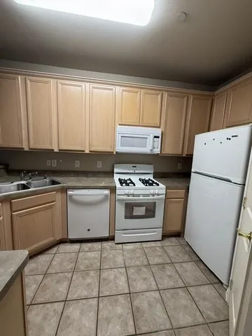 a kitchen with a stove a sink and a refrigerator