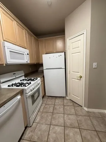 a kitchen with a stove a refrigerator and a cabinets