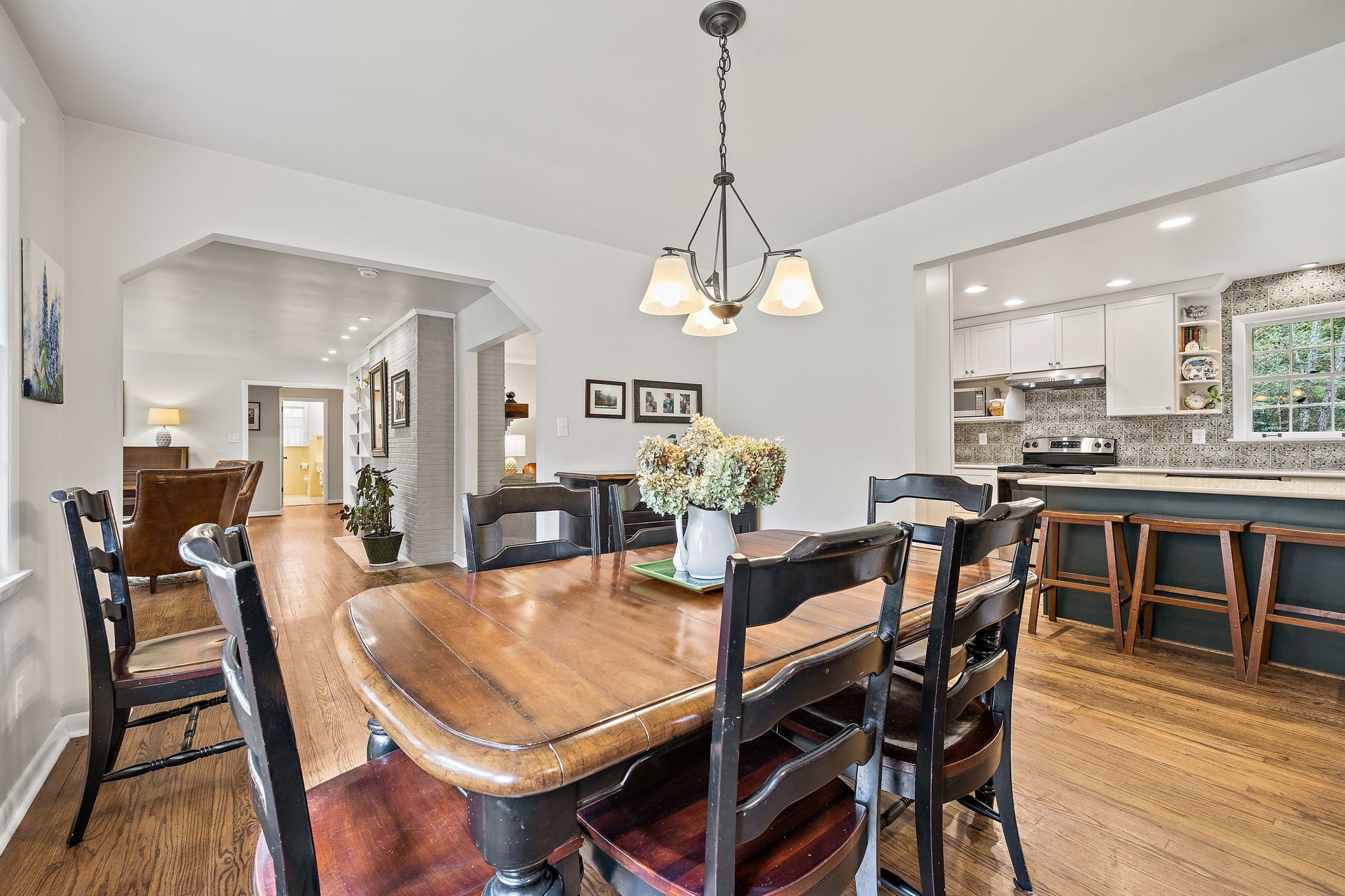 7767 Fernvale Road Fairview, TN 37062 - Photo 32 of 70 a view of a dining room and livingroom with furniture wooden floor a chandelier