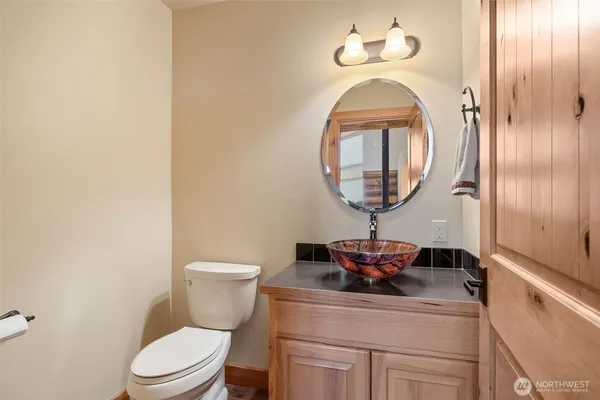a bathroom with a toilet and a mirror