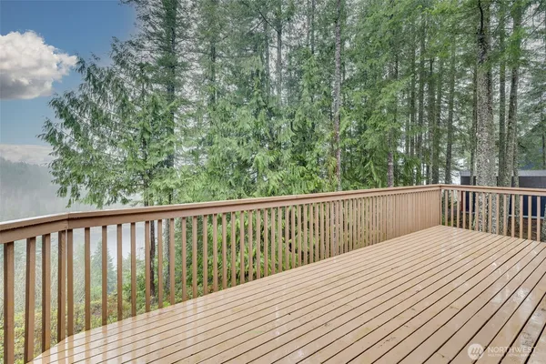 a balcony with wooden floor and fence