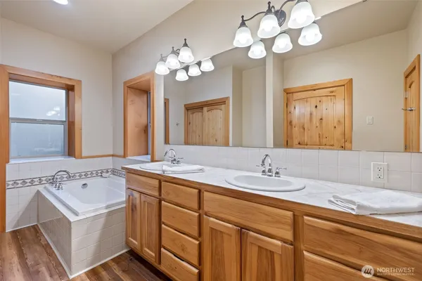 a bathroom with a sink double vanity granite and a mirror