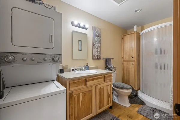 a bathroom with a sink a toilet and mirror
