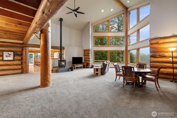 a view of a livingroom with furniture and a large window