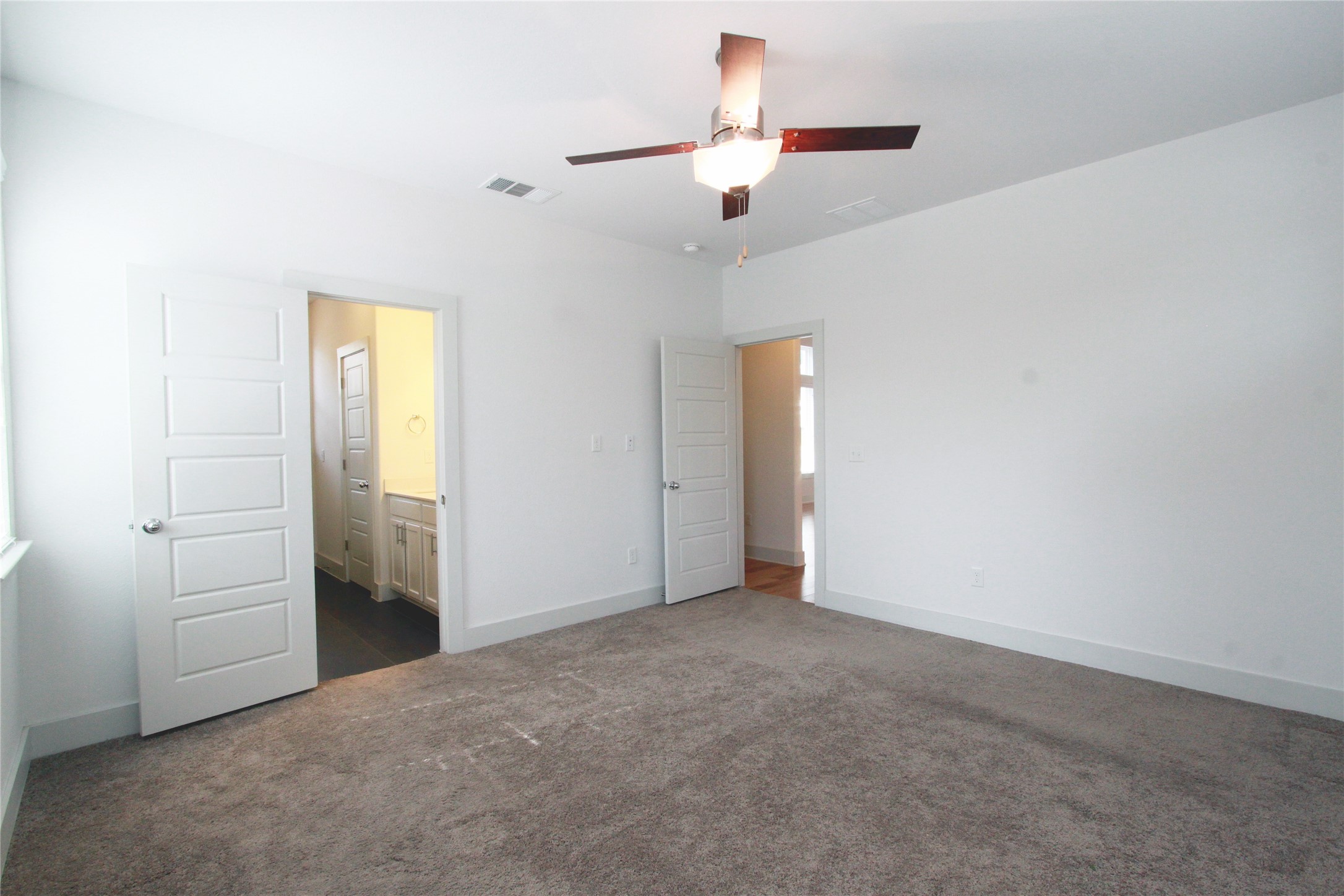 1507 Homespun Road Austin, TX 78745 - Photo 16 of 35 Spacious room featuring neutral carpeting, a ceiling fan with integrated lighting, and white trim