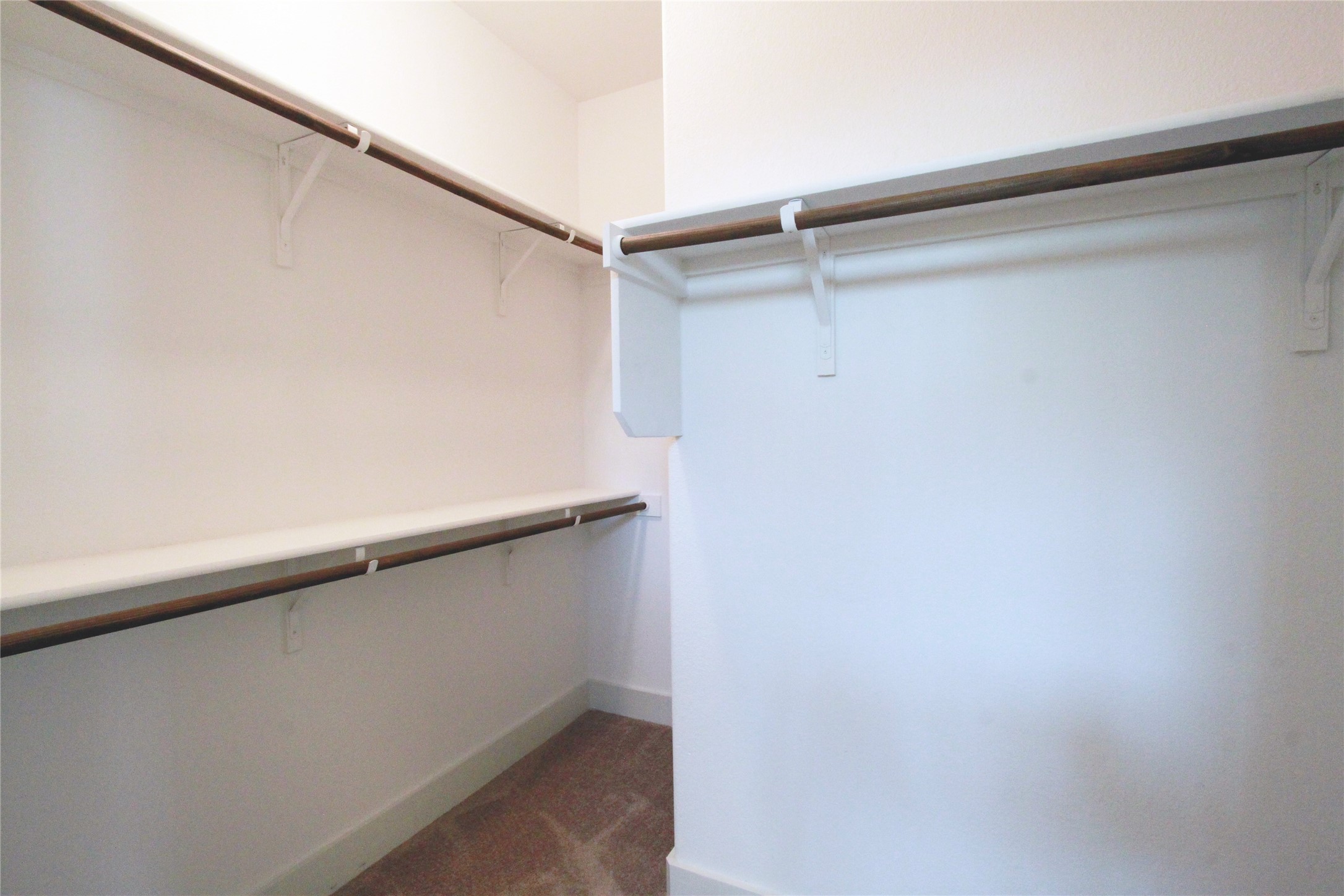 1507 Homespun Road Austin, TX 78745 - Photo 20 of 35 Spacious walk-in closet featuring white walls, white shelving, and wood-finish hanging rods