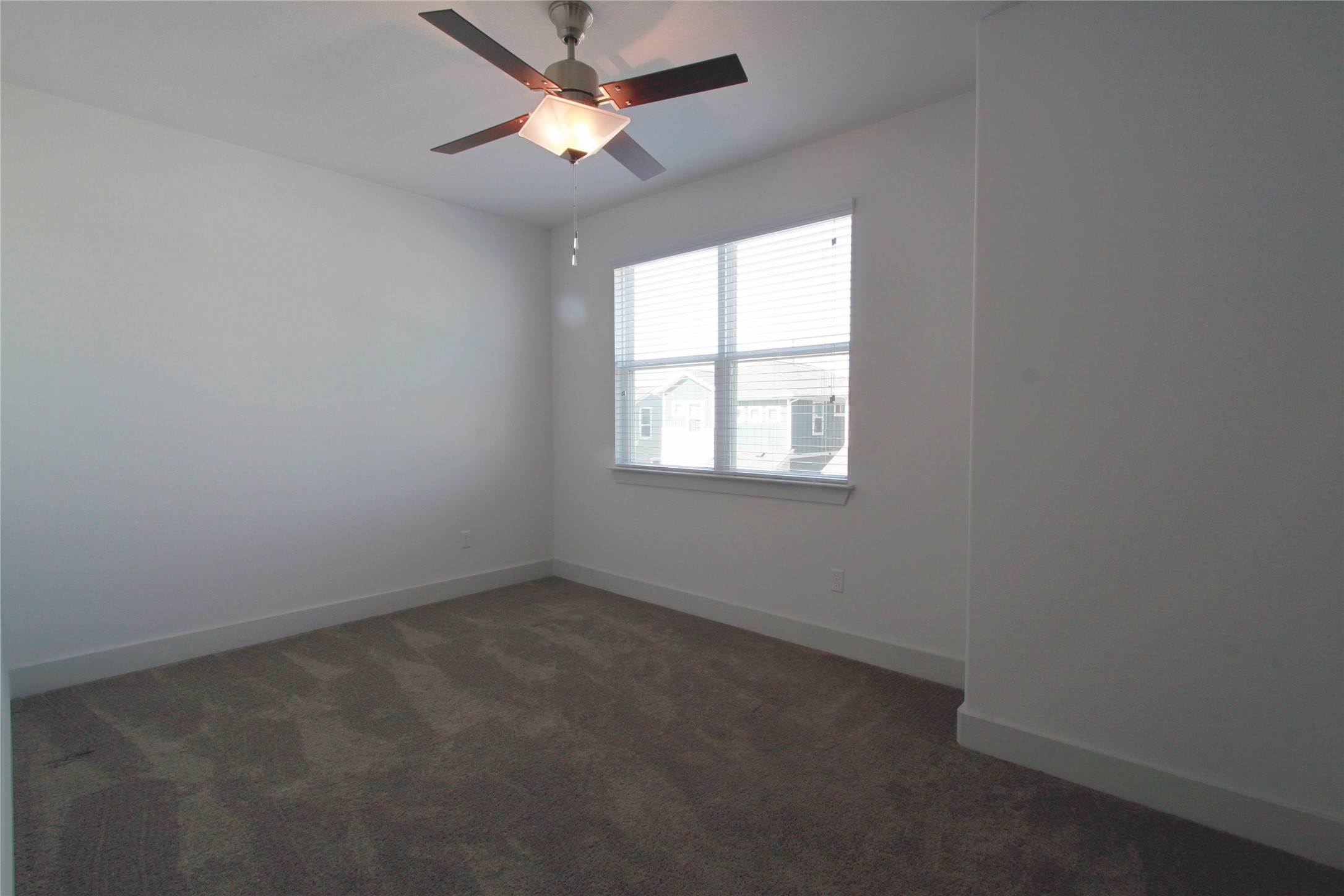 1507 Homespun Road Austin, TX 78745 - Photo 26 of 35 Carpeted room featuring a ceiling fan with light fixture, a window with blinds, and white baseboards